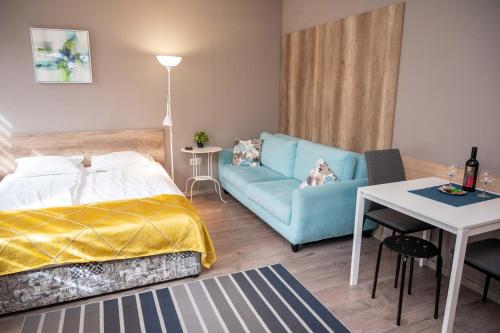 a bedroom with a bed and a couch and a table at All Seasons Apartments Iglika 2 in Borovets