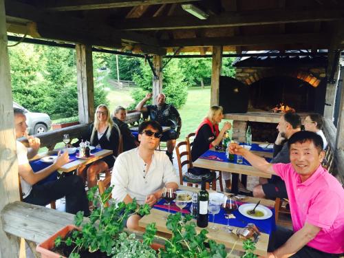 a group of people sitting at tables in a restaurant at Pansion Danica in Rastovača