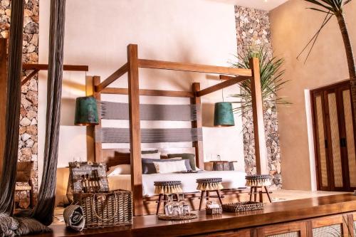 a bedroom with a large bed in a room at Oriundo Luxury Nature Villas in Valladolid