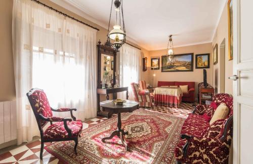 a living room with a couch and chairs and a table at Apartamentos Salmerones in Alhama de Granada