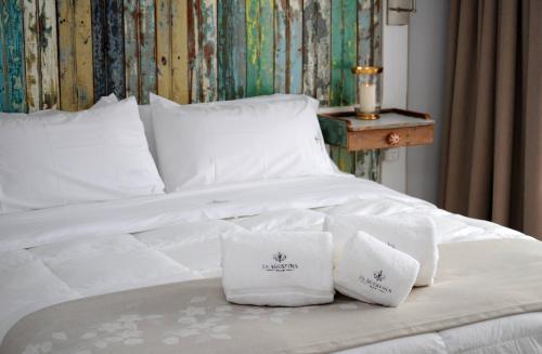 En eller flere senge i et værelse på La Agustina Apart Boutique