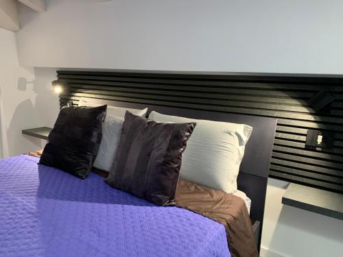 a bedroom with a bed with purple sheets and pillows at Villa Primodì in Bologna