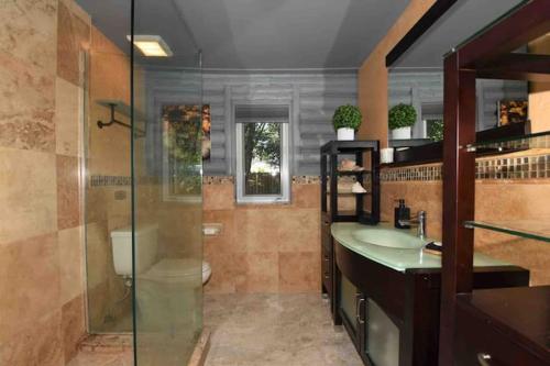 a bathroom with a shower and a sink and a toilet at SexyVibe2/private room/out shower/pool/clothin opt in Fort Lauderdale