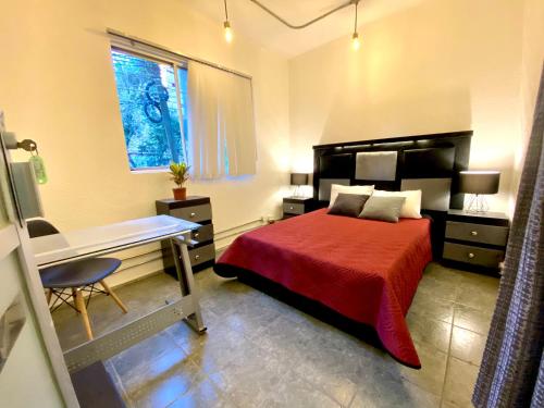 a bedroom with a bed and a desk in it at ROOMIES HOSTEL Reforma-El ángel in Mexico City