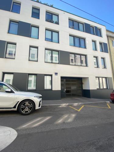 a white car parked in front of a building at PA14 Modern apartment with a private garage near Schönbrunn Palace T5 in Vienna