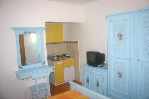 a small kitchen with a sink and a mirror at Apartments Savina in Budva