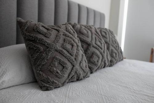 a pile of pillows sitting on top of a bed at Luxurious Private Beach Getaway in Punta Mita