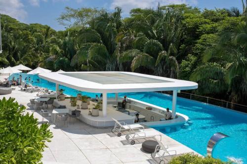 a pool with a pavilion next to a swimming pool at Luxurious Private Beach Getaway in Punta Mita