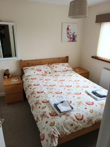 a bedroom with a bed with a laptop on it at 3 bedroom house in Barrow in Furness