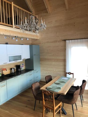a kitchen and dining room with a table and chairs at MyHolzhaus - zum Wohlfühlen in Gröbming