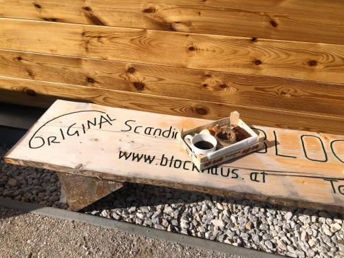 a wooden bench with a box on top of it at MyHolzhaus - zum Wohlfühlen in Gröbming