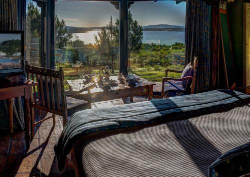 a bedroom with a bed and a large window at Las Cumbres Hotel in Punta del Este