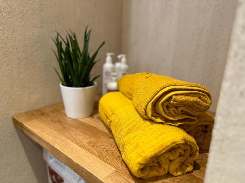 a yellow towel sitting on top of a wooden table at Magical two bedroom apartment in Viljandi in Viljandi