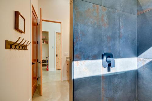 two pictures of a bathroom with a blue wall at Rock Creek Retreat Creekside Cabin Near Red Lodge in Red Lodge