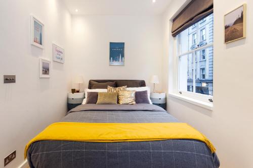 a bedroom with a bed and a window at Welcome London Seven Dials in London