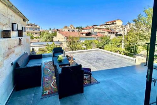 a patio with furniture and a view of a city at Casa Chilai Cappadocia in Urgup
