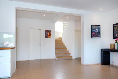 a hallway with white walls and stairs in a house at Villa Marceline in Prvić Luka