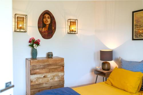 a bedroom with a bed and a picture of a woman on the wall at Villa Marceline in Prvić Luka
