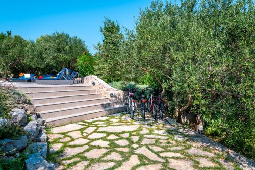 a bike parked next to a set of stairs at Villa Marceline in Prvić Luka