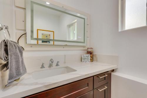 a white bathroom with a sink and a mirror at Cozy Escondido Escape Near Hiking and Downtown! in Escondido