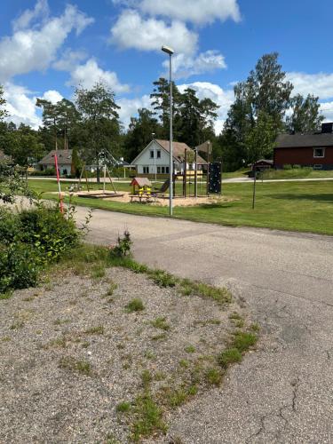 a park with a playground with a horse in the distance at Family Friendly Villa Close To Ullared, 3bedrooms in Älvsered