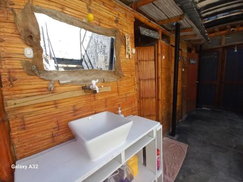 a bathroom with a sink and a window at Wally's House Mancora in Máncora