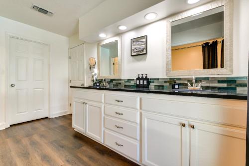 a bathroom with a sink and a mirror at Stunning Baton Rouge Home with Pool Near LSU! in Baton Rouge