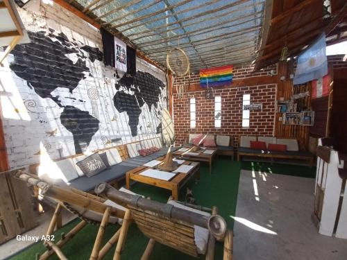 a room with a map of the world on the wall at Wally's House Mancora in Máncora