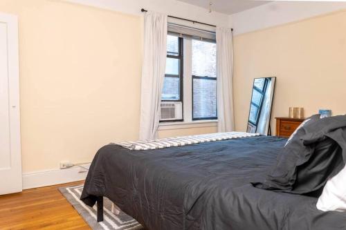 um quarto com uma cama e uma janela em Hoboken Haven – Heart of town! em Hoboken