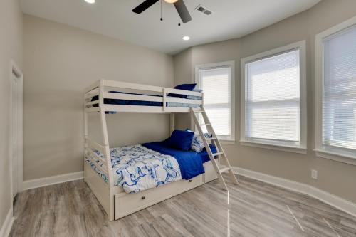 a bunk bed in a room with a ceiling fan at 4 Mi to Dtwn Upscale Home in Baltimore in Baltimore