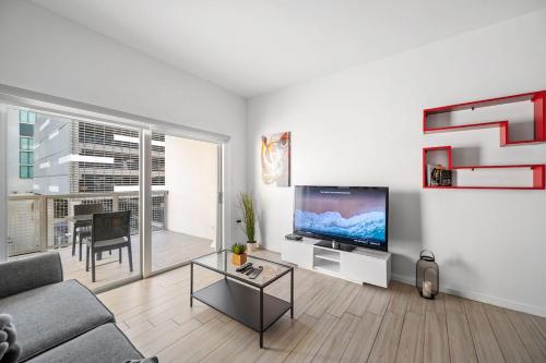 a living room with a couch and a flat screen tv at Subtle 2 Bed in Edgewater Downtown with Free Parking in Miami