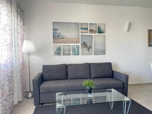a living room with a couch and a glass table at Stanza Mare Beach Front in Punta Cana