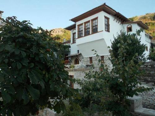 a large white house on top of a mountain at Hotel Gjirokastra in Gjirokastër