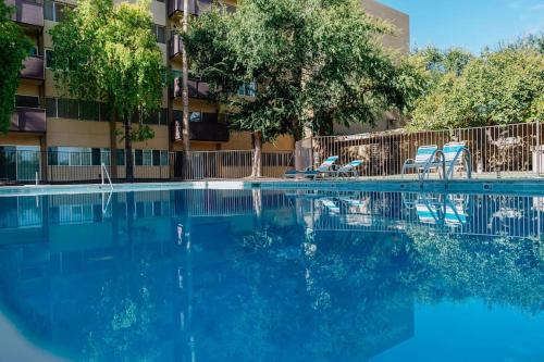 a swimming pool with blue water in front of a building at *Msg for 5%off*2Bed2Bath KingBeds MidtownPHX Condo in Phoenix