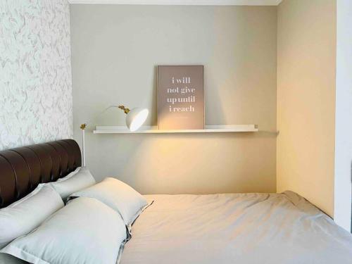 a bedroom with a bed with a book on the wall at [300m to PRJ] Expo Friendly 2BR in Jakarta