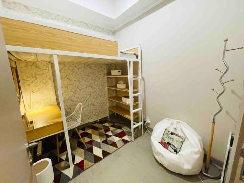 a small room with bunk beds and a floor at [300m to PRJ] Expo Friendly 2BR in Jakarta