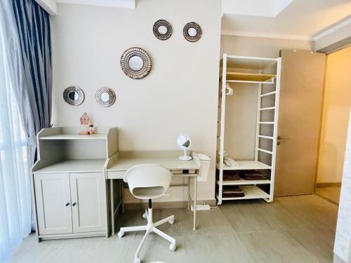 a desk and a chair in a room at [300m to PRJ] Expo Friendly 2BR in Jakarta