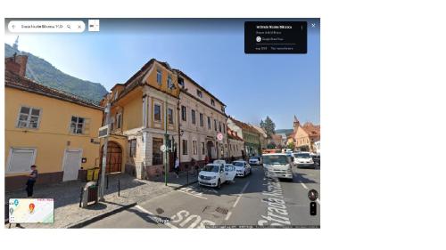 a city street with cars parked on the street at Blancris Boutique in Braşov