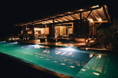 a swimming pool at night with a house at Casa Altanera in Recado