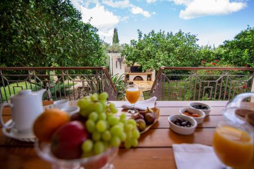 a table with grapes and other bowls of fruit at Villa Komfort in Zakynthos