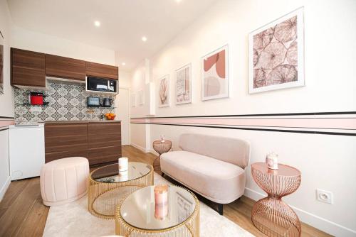 un salon avec un canapé, une table et des chaises dans l'établissement Cosy Home in Haut Marais II, à Paris