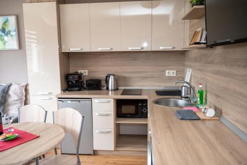 a small kitchen with a sink and a table at All Seasons Apartments Iglika 2 in Borovets