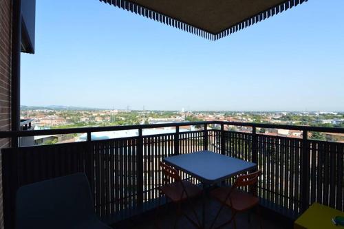 a balcony with a table and a view of a city at La casa di LUCA in Imola