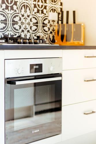 a kitchen with a white oven and white cabinets at Crescent Moon in Lake Tekapo
