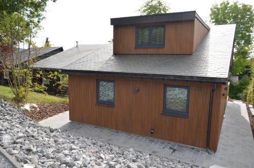 a house with a roof on a pile of rocks at Holiday Home Mooi-Gemmenich in Plombières