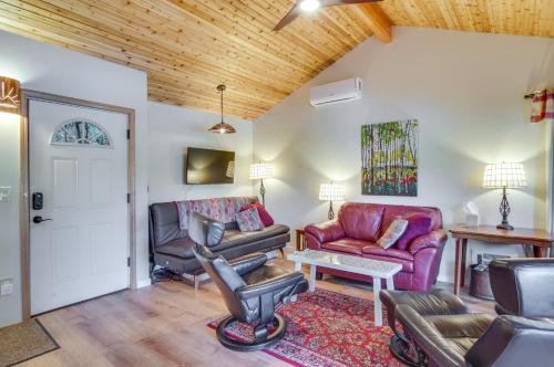 a living room with leather furniture and a wooden ceiling at Lakefront Snohomish Cottage with Private Dock! in Snohomish