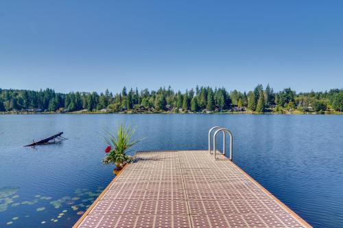 a wooden dock in the middle of a lake at Lakefront Snohomish Cottage with Private Dock! in Snohomish