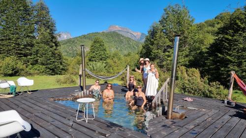 a group of people in the water in a pool at Peuma Lodge Patagonia in Futaleufú