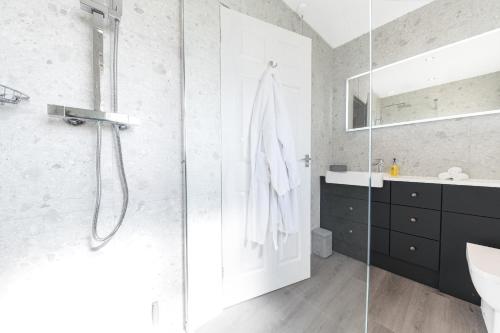 a bathroom with a shower and a sink at Colt Park Cottage in Ulverston
