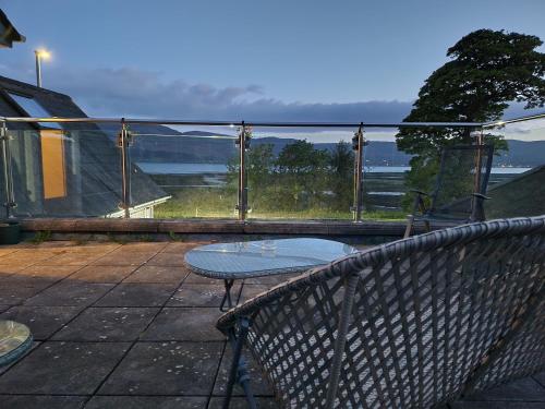 a balcony with a table and a view of the water at The Oystercatcher in Rostrevor